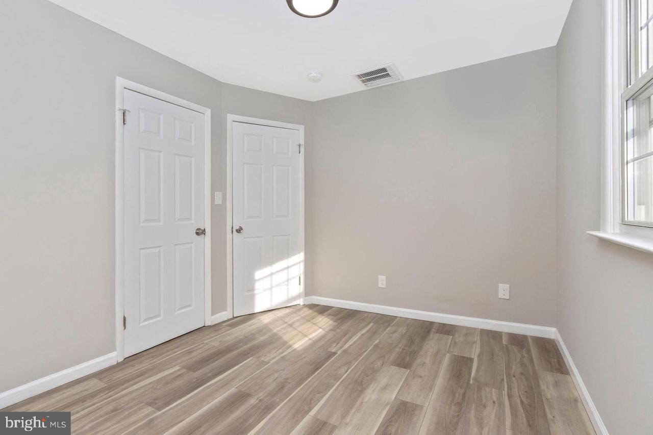 6738 Allview Drive Columbia, MD 21046 - Photo 20 of 33 a view of an empty room with wooden floor and a window