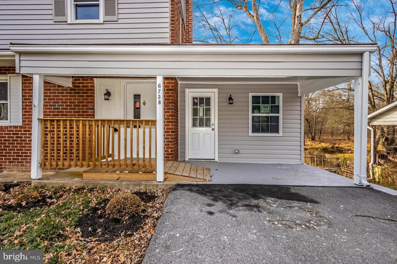 6738 Allview Drive Columbia, MD 21046 - Photo 31 of 33 a view of a house with a small yard and wooden floor and fence