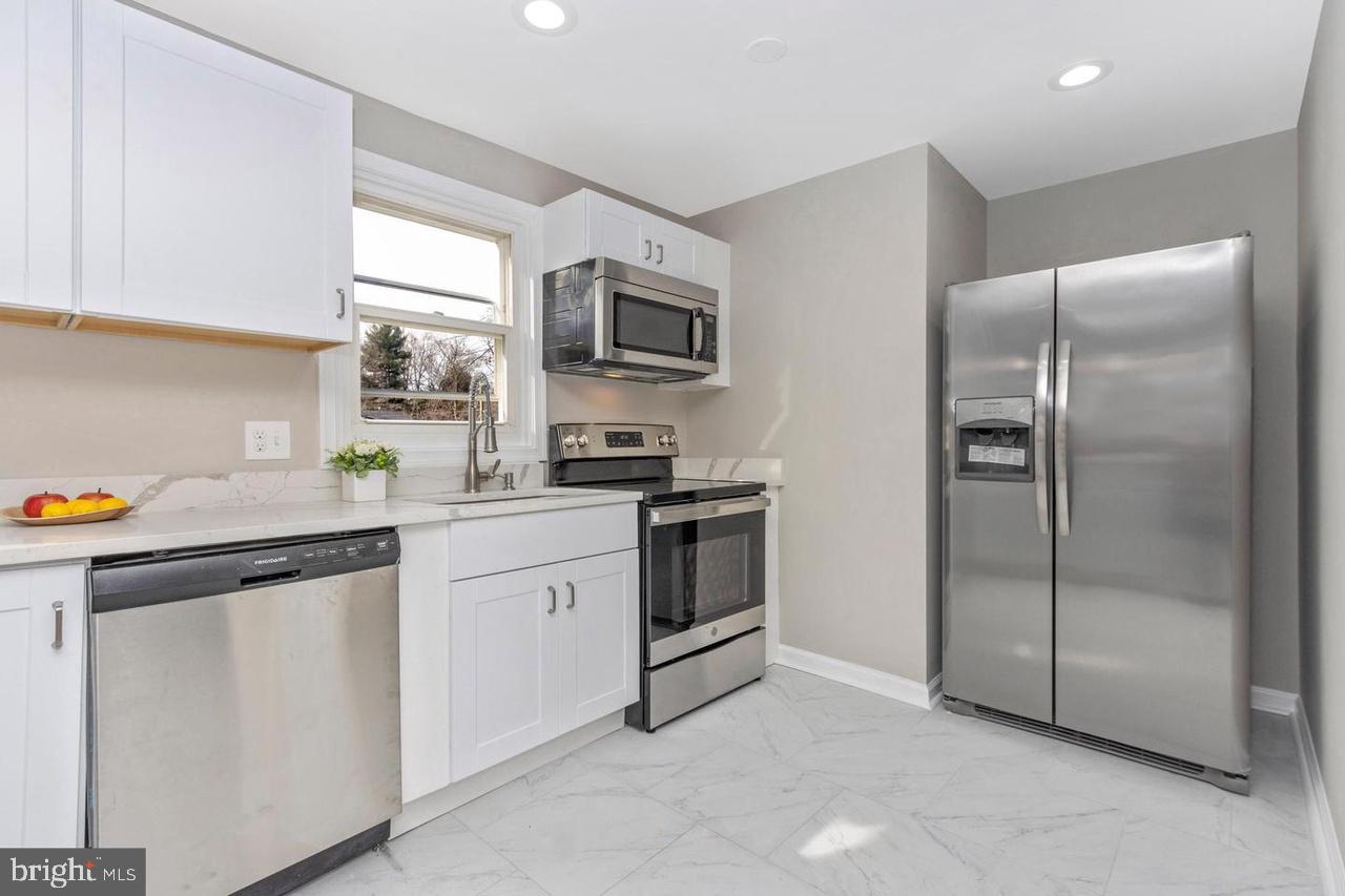 6738 Allview Drive Columbia, MD 21046 - Photo 8 of 33 a kitchen with a refrigerator sink and cabinets