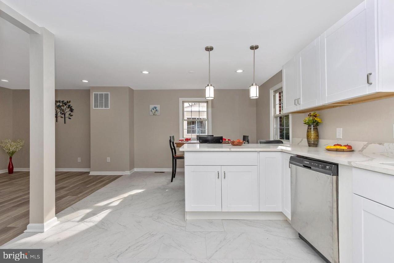 6738 Allview Drive Columbia, MD 21046 - Photo 10 of 33 a kitchen with white cabinets and sink