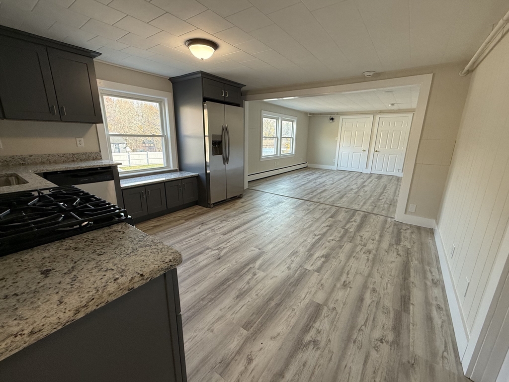 866 Center Street, Unit 2 Middleboro, MA 02346 - Photo 4 of 11 a view of a kitchen with wooden floor and electronic appliances