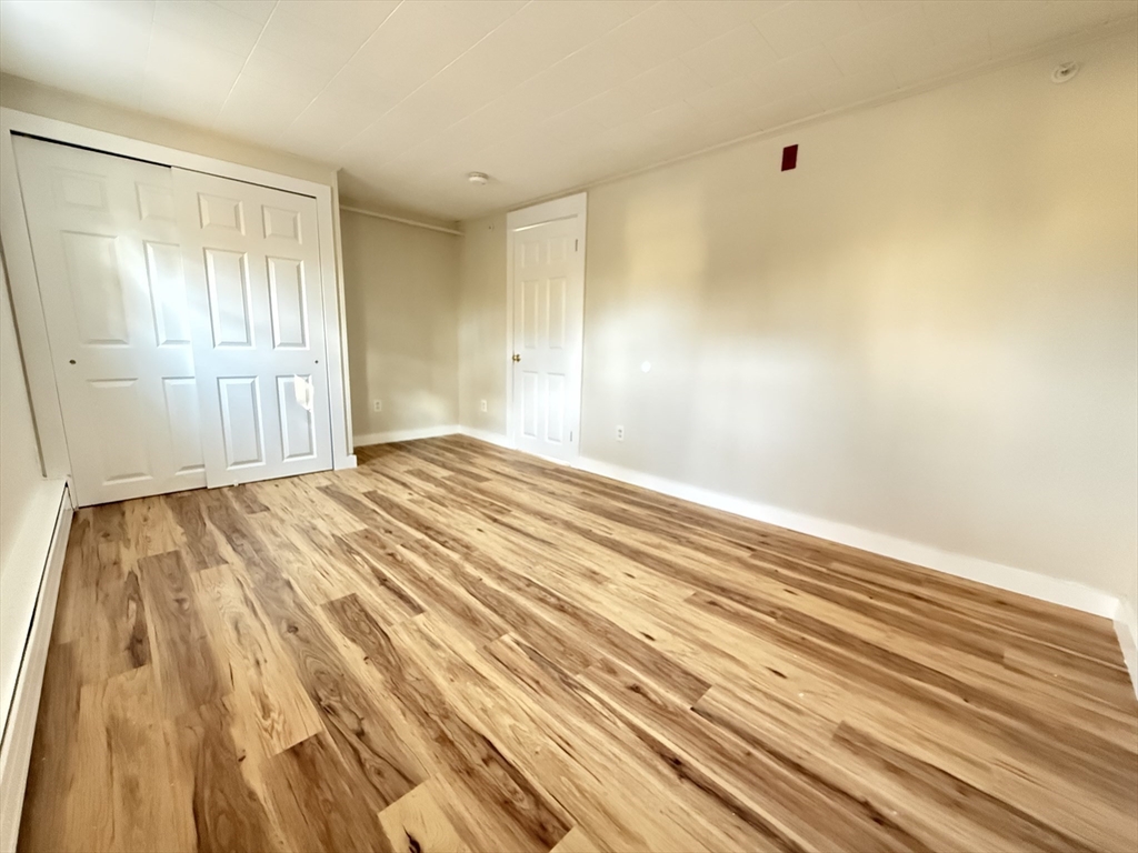 866 Center Street, Unit 2 Middleboro, MA 02346 - Photo 8 of 11 a view of an empty room with wooden floor