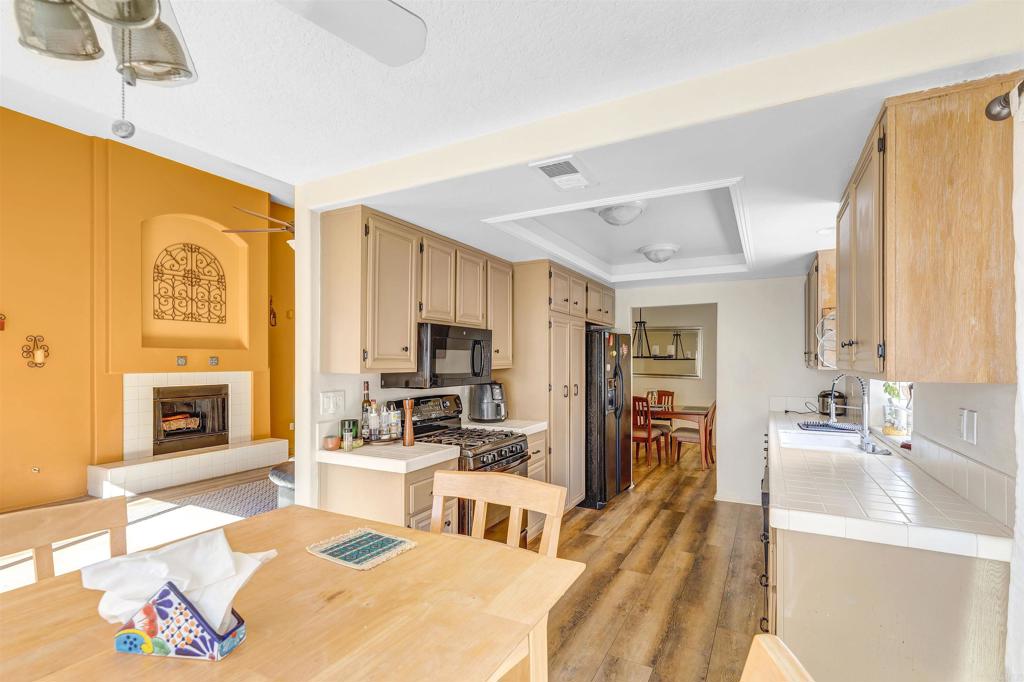 4559 Coronado Drive Oceanside, CA 92057 - Photo 11 of 29 a living room with stainless steel appliances furniture a fireplace and a open kitchen view
