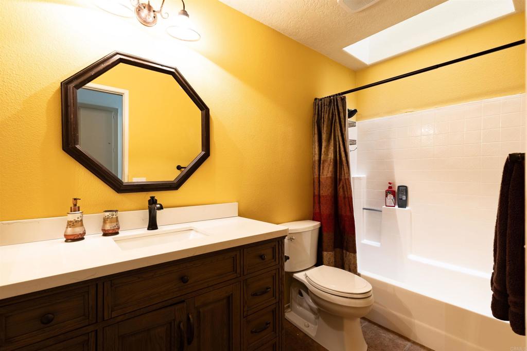 4559 Coronado Drive Oceanside, CA 92057 - Photo 21 of 29 a bathroom with a sink mirror vanity and toilet