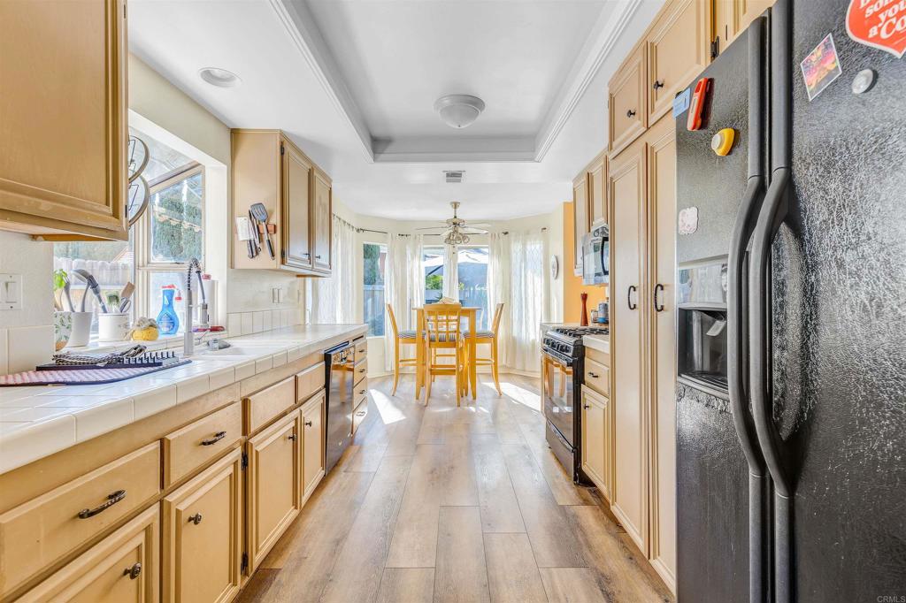 4559 Coronado Drive Oceanside, CA 92057 - Photo 8 of 29 a view of a kitchen with lots of counter top space and wooden floor