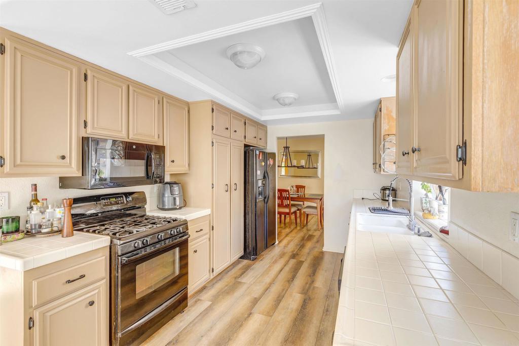 4559 Coronado Drive Oceanside, CA 92057 - Photo 9 of 29 a kitchen with stainless steel appliances a stove a sink and a refrigerator