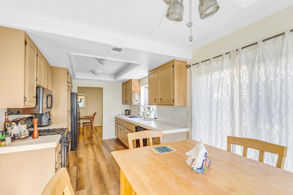 4559 Coronado Drive Oceanside, CA 92057 - Photo 10 of 29 a view of a dining room with furniture window and wooden floor