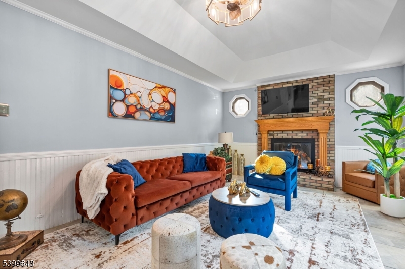 512 Township Line Road Hillsborough, NJ 08844 - Photo 12 of 40 a living room with furniture a fireplace and a flat screen tv