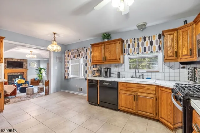 a kitchen with stainless steel appliances granite countertop a sink and cabinets