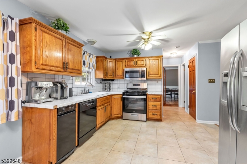 512 Township Line Road Hillsborough, NJ 08844 - Photo 10 of 40 a kitchen with stainless steel appliances granite countertop a refrigerator and a stove top oven