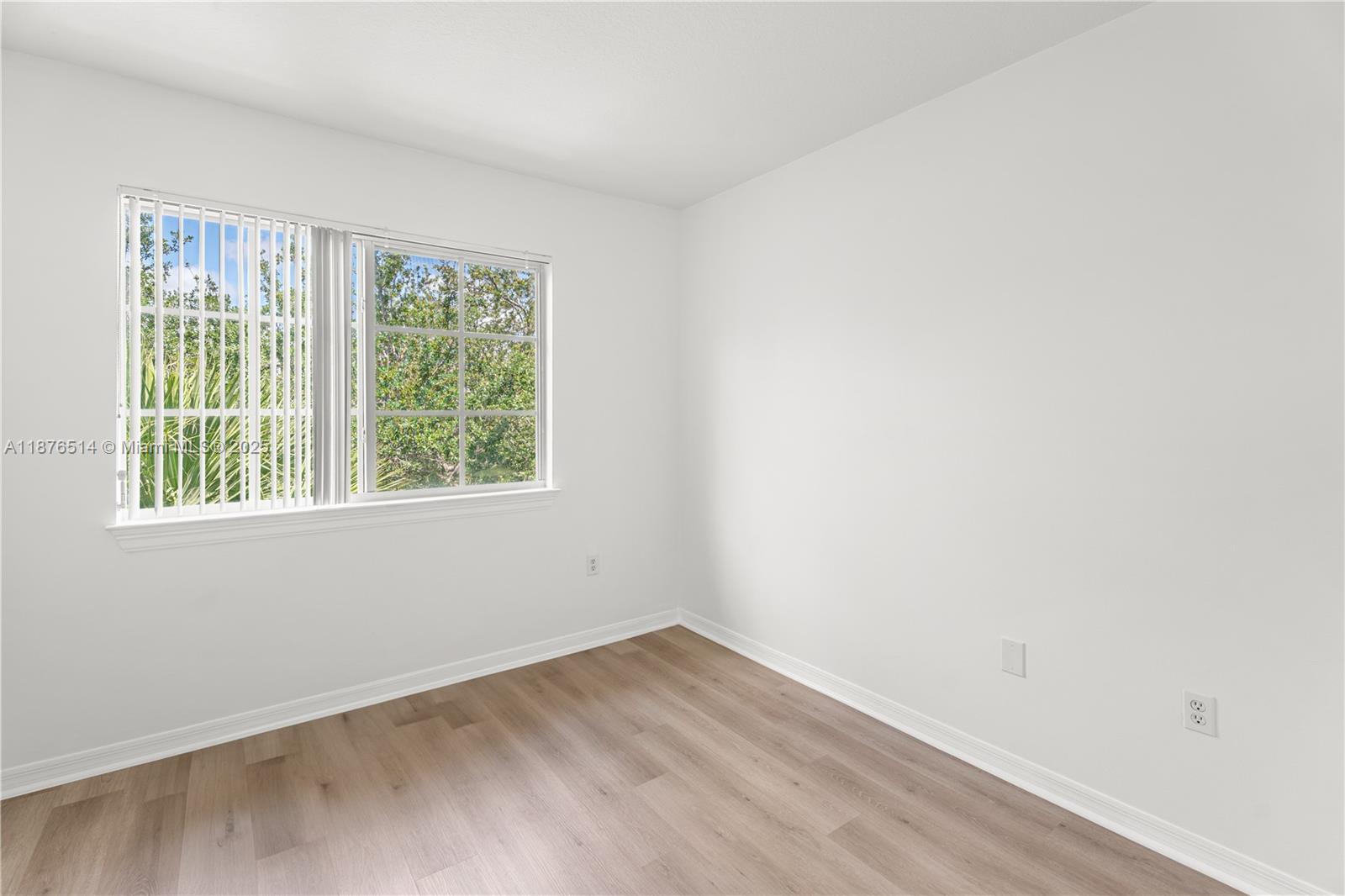 6851 Southwest 44th Street, Unit 210 Miami, FL 33155 - Photo 11 of 23 an empty room with a window