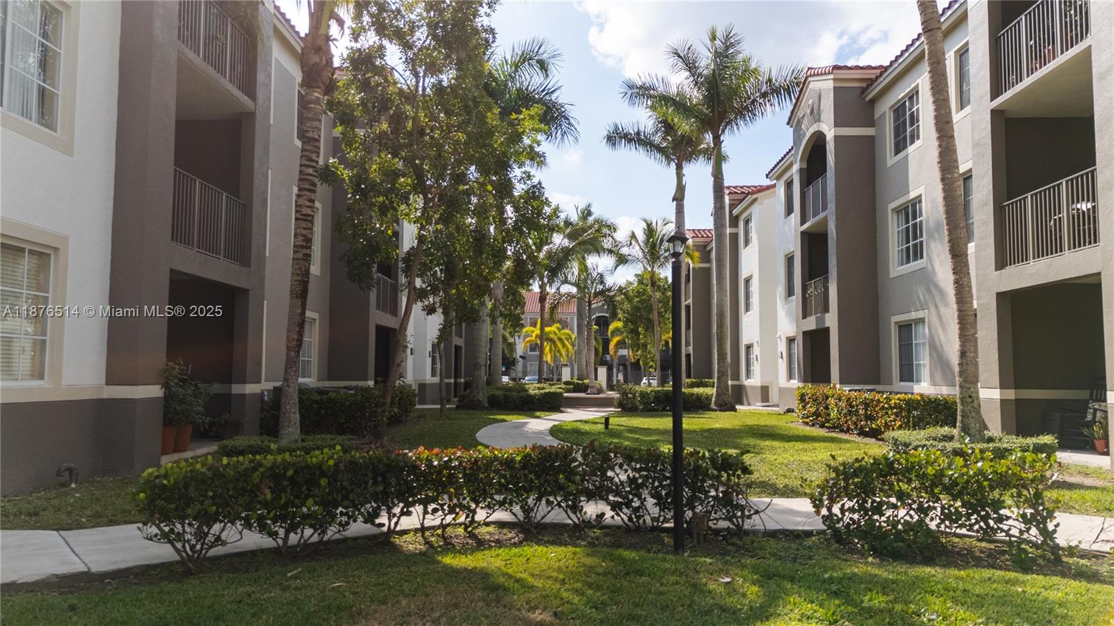 6851 Southwest 44th Street, Unit 210 Miami, FL 33155 - Photo 5 of 23 a garden with trees in front of it