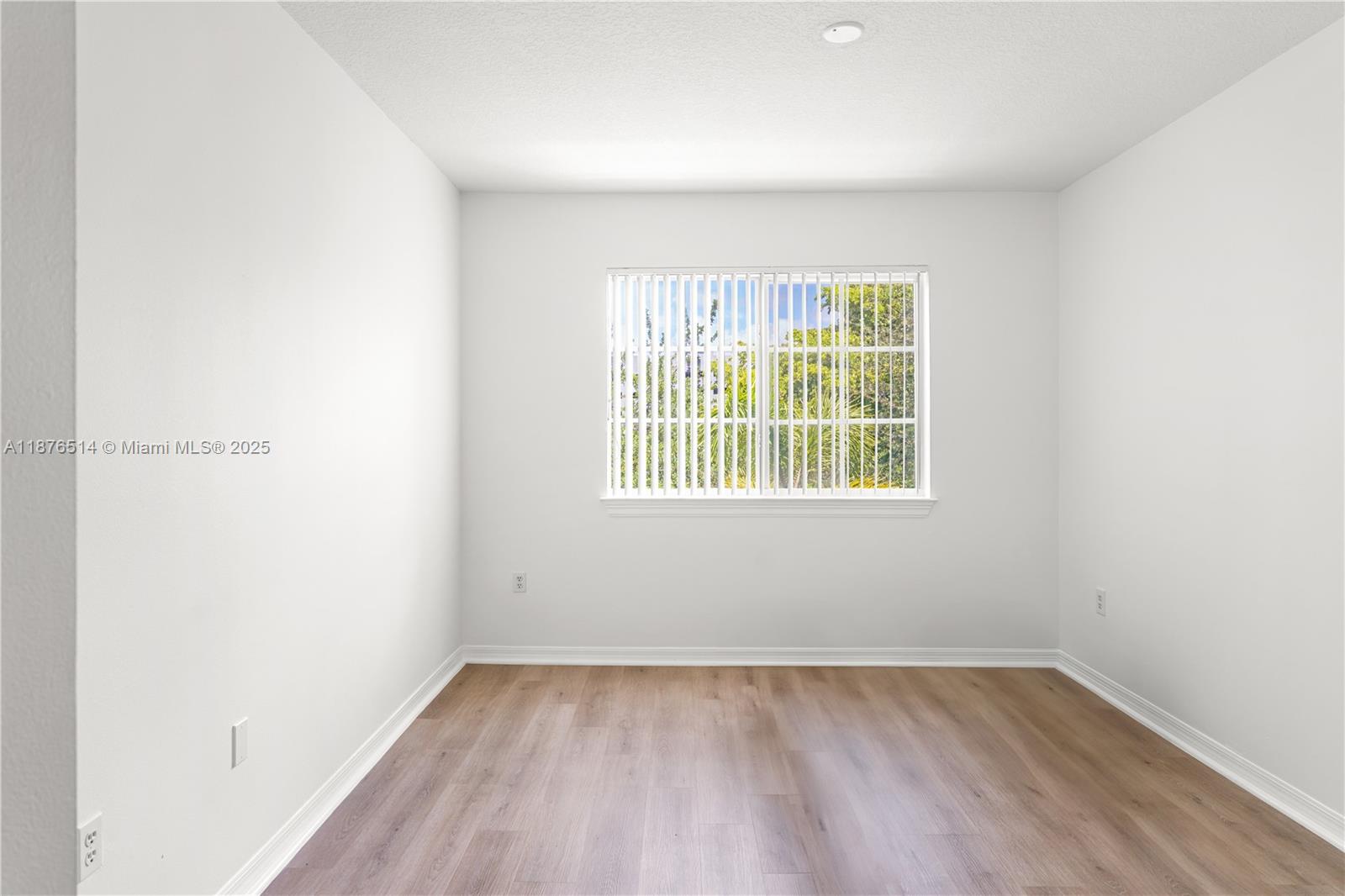 6851 Southwest 44th Street, Unit 210 Miami, FL 33155 - Photo 7 of 23 an empty room with a window