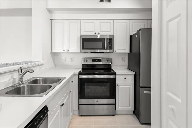 a kitchen with a sink stove and refrigerator