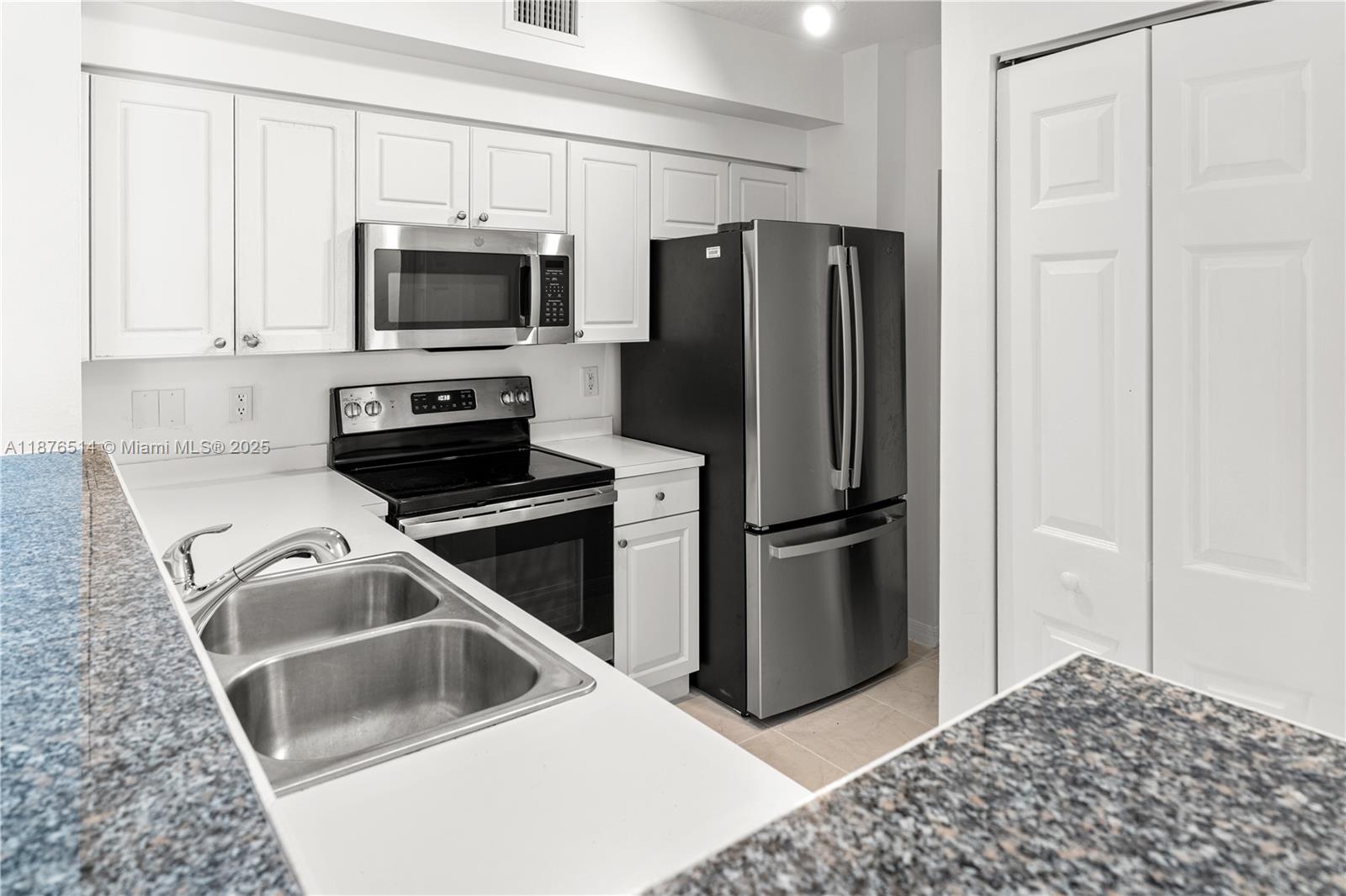 6851 Southwest 44th Street, Unit 210 Miami, FL 33155 - Photo 9 of 23 a kitchen with a refrigerator sink and microwave