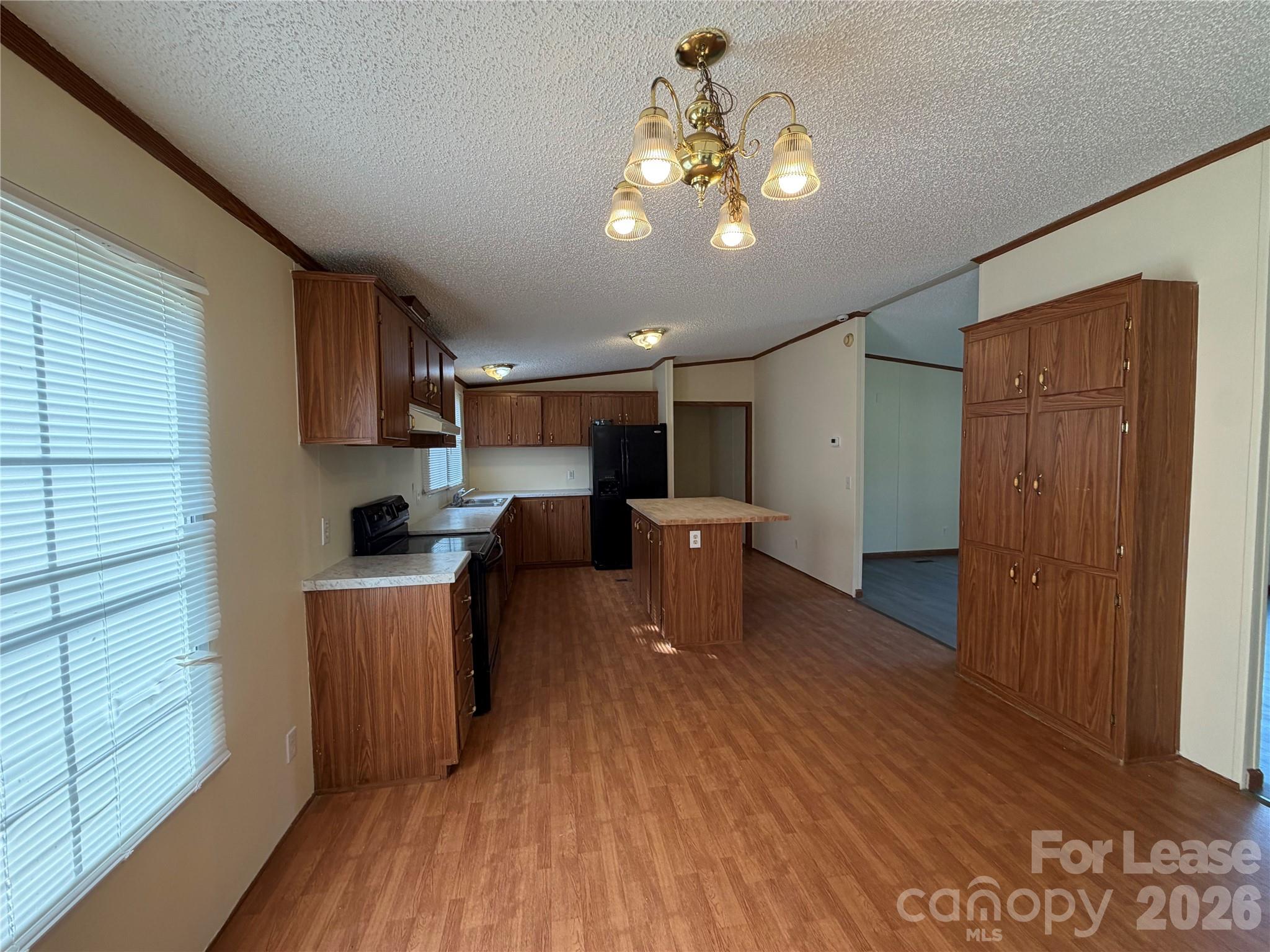 7141 Lingerfelt Road Vale, NC 28168 - Photo 13 of 25 a living room with stainless steel appliances kitchen island granite countertop a table chairs and a wooden floor