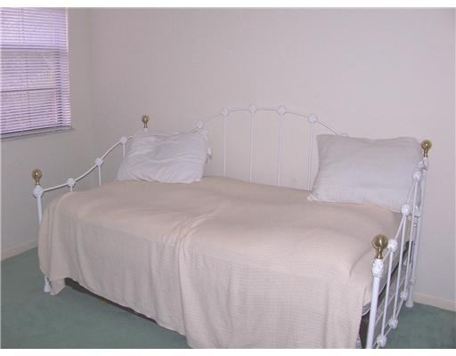 7727 La Mirada Drive, Unit 118 Boca Raton, FL 33433 - Photo 11 of 16 a bedroom with a bed and a night stand