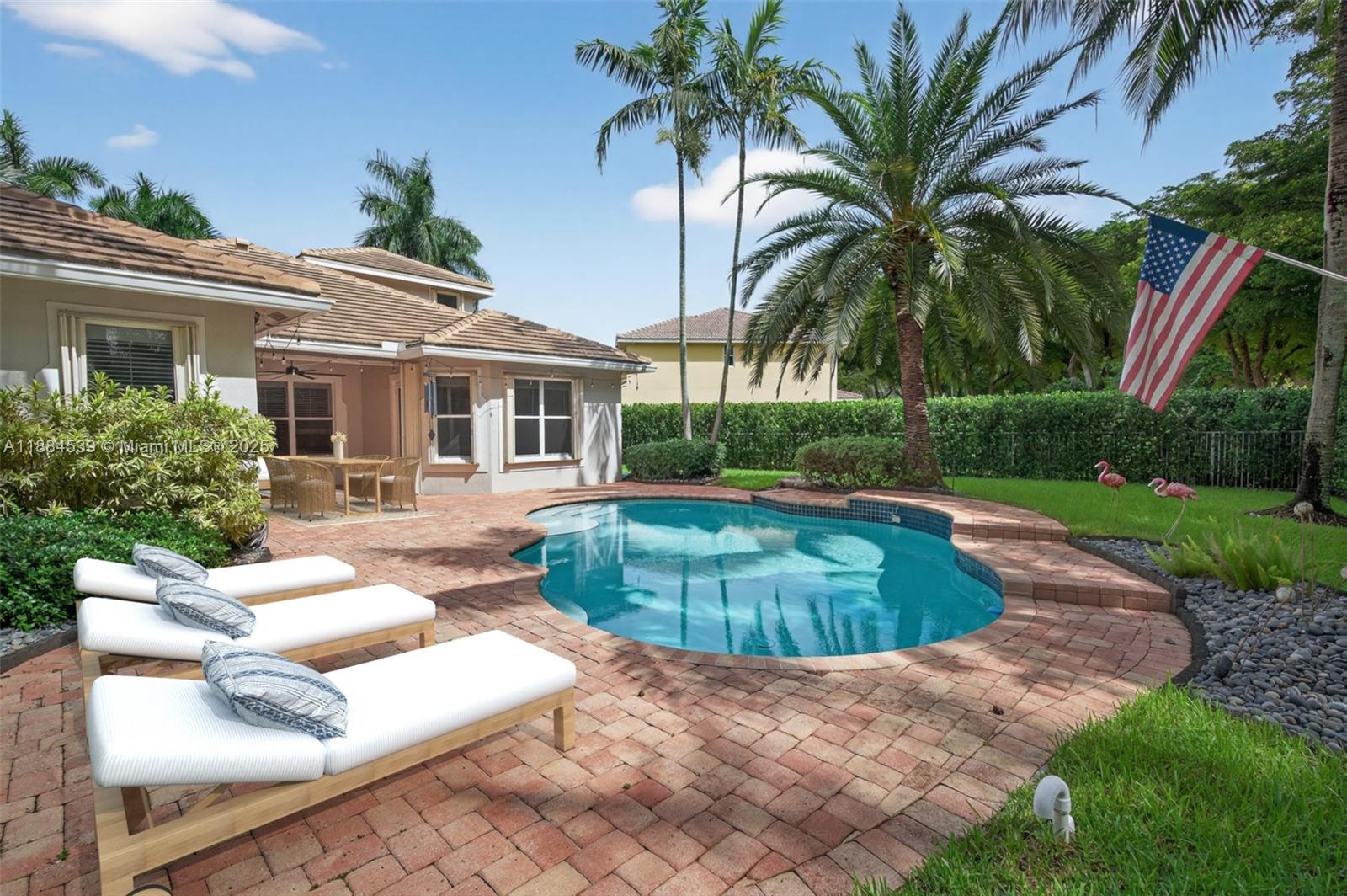 a view of a house with swimming pool and a small yard