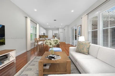 a bedroom with a bed a mirror and a window