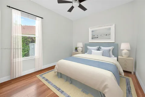a front view of a house with a yard and palm trees