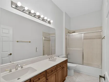 a view of a swimming pool with a yard and trees