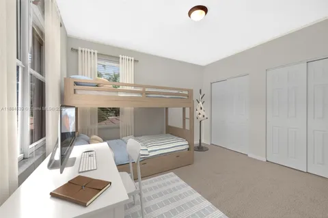 an aerial view of a house with a yard and lake view