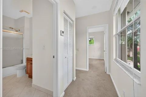 an aerial view of a house with a yard and lake view