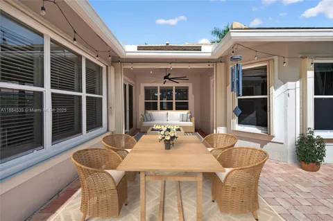 a view of a hallway with wooden floor and a bathroom