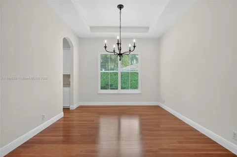 a kitchen with stainless steel appliances kitchen island granite countertop a stove and a wooden floors