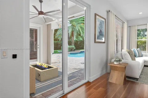 a view of a hallway with wooden floor and glass door