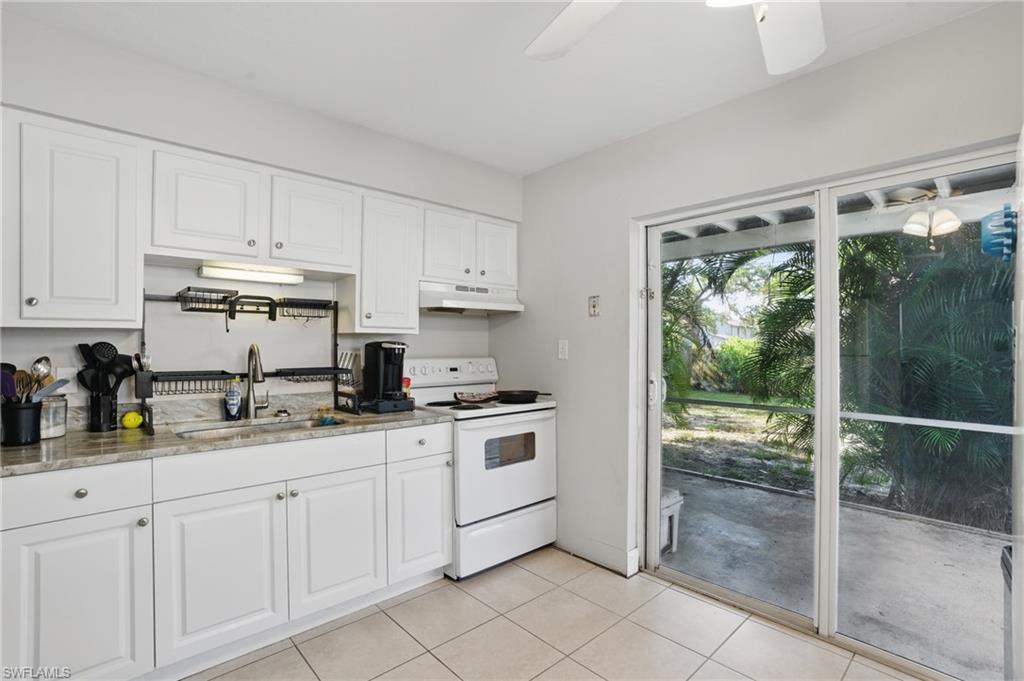 11580 Dean Street, Unit 582 Bonita Springs, FL 34135 - Photo 12 of 22 Kitchen featuring under cabinet range hood, white electric range, a sink, a ceiling fan, and white cabinetry