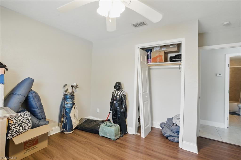 11580 Dean Street, Unit 582 Bonita Springs, FL 34135 - Photo 18 of 22 Bedroom with wood finished floors, ceiling fan, a closet, and baseboards