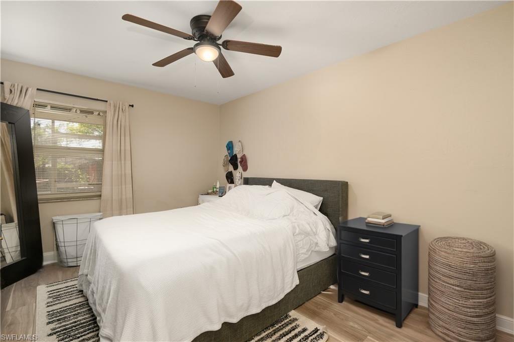 11580 Dean Street, Unit 582 Bonita Springs, FL 34135 - Photo 7 of 22 Bedroom featuring light wood-type flooring, baseboards, and ceiling fan