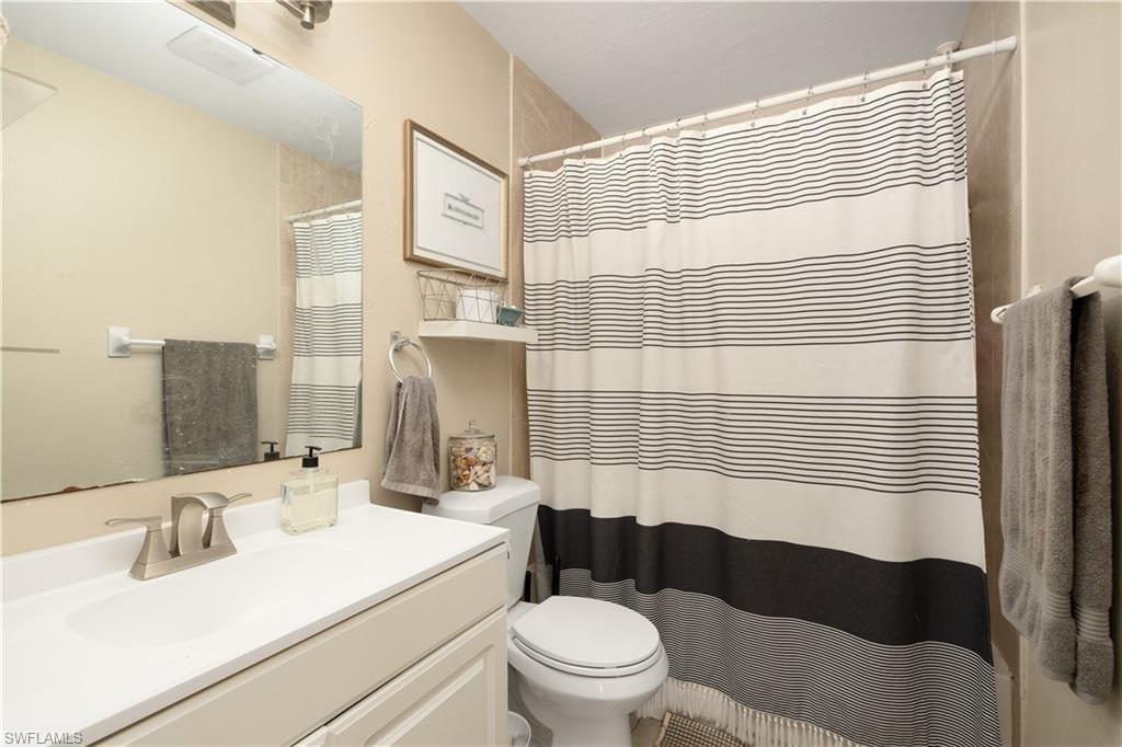 11580 Dean Street, Unit 582 Bonita Springs, FL 34135 - Photo 9 of 22 Bathroom with toilet, vanity, and a shower with curtain