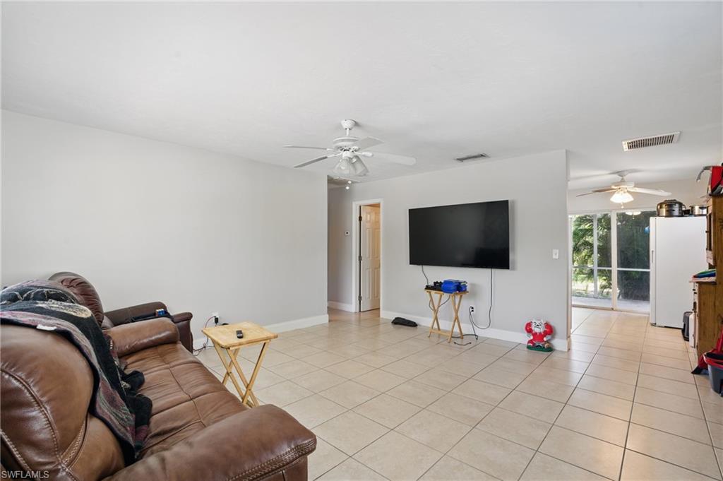 11580 Dean Street, Unit 582 Bonita Springs, FL 34135 - Photo 10 of 22 Living area with a ceiling fan, light tile patterned floors, and baseboards
