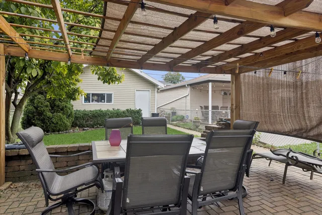 a view of a dining room with furniture and chandelier