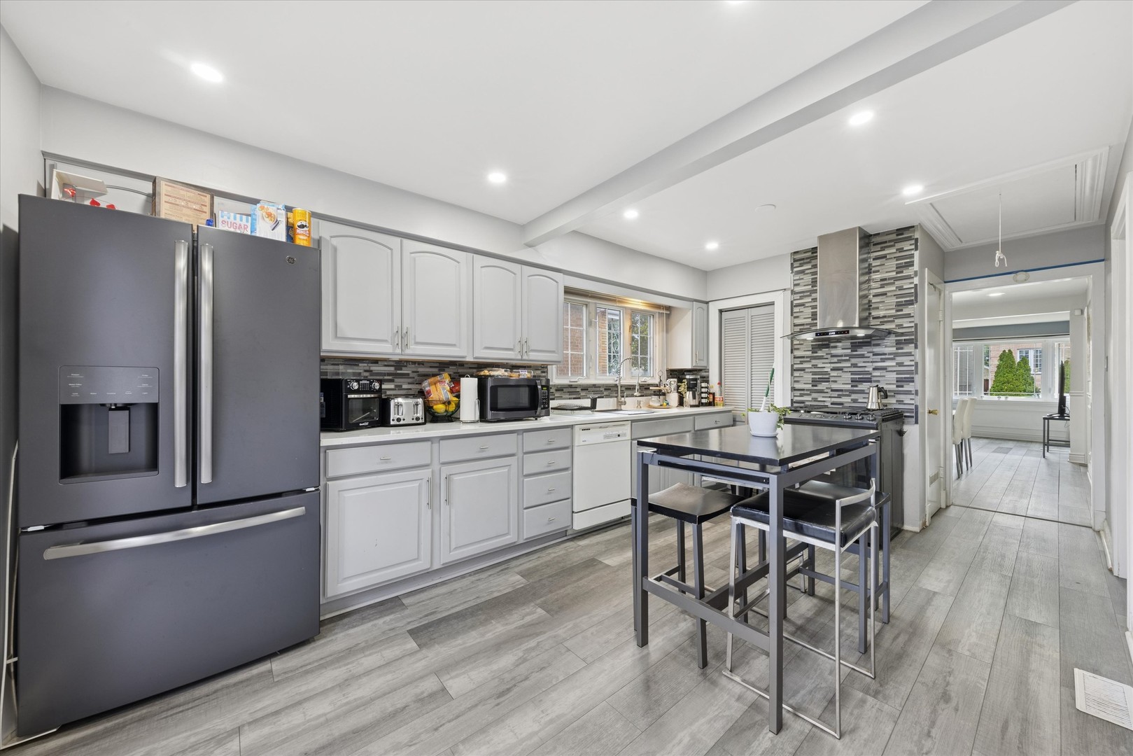 7211 West 58th Place Summit, IL 60501 - Photo 3 of 15 a kitchen with a refrigerator a table and chairs