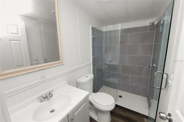 a bathroom with a glass shower door