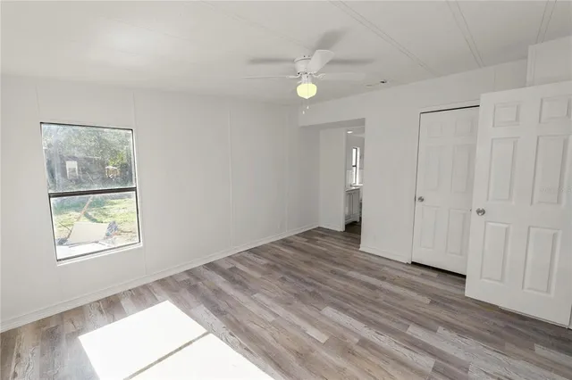 a view of empty room with wooden floor