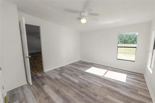 wooden floor in an empty room with a window