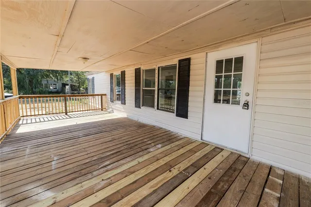 a view of a balcony with wooden floor