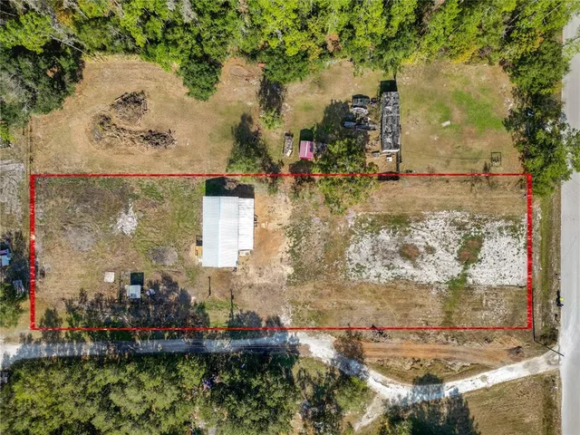 an aerial view of a houses with a yard