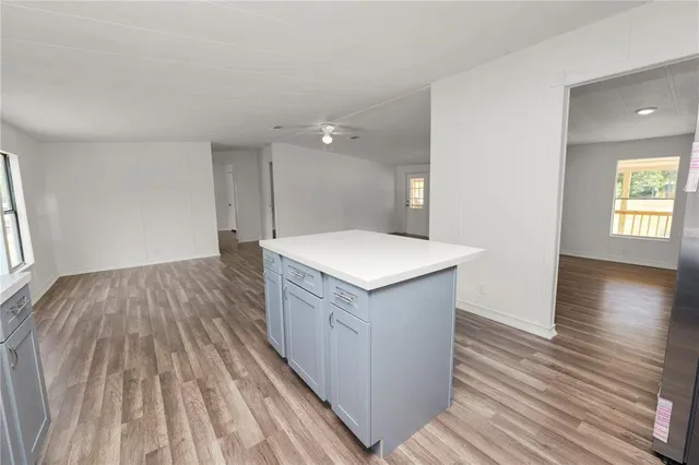 a kitchen with stainless steel appliances a sink a stove a microwave and cabinets