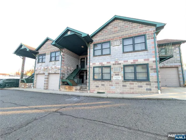 a view of a brick house with large windows