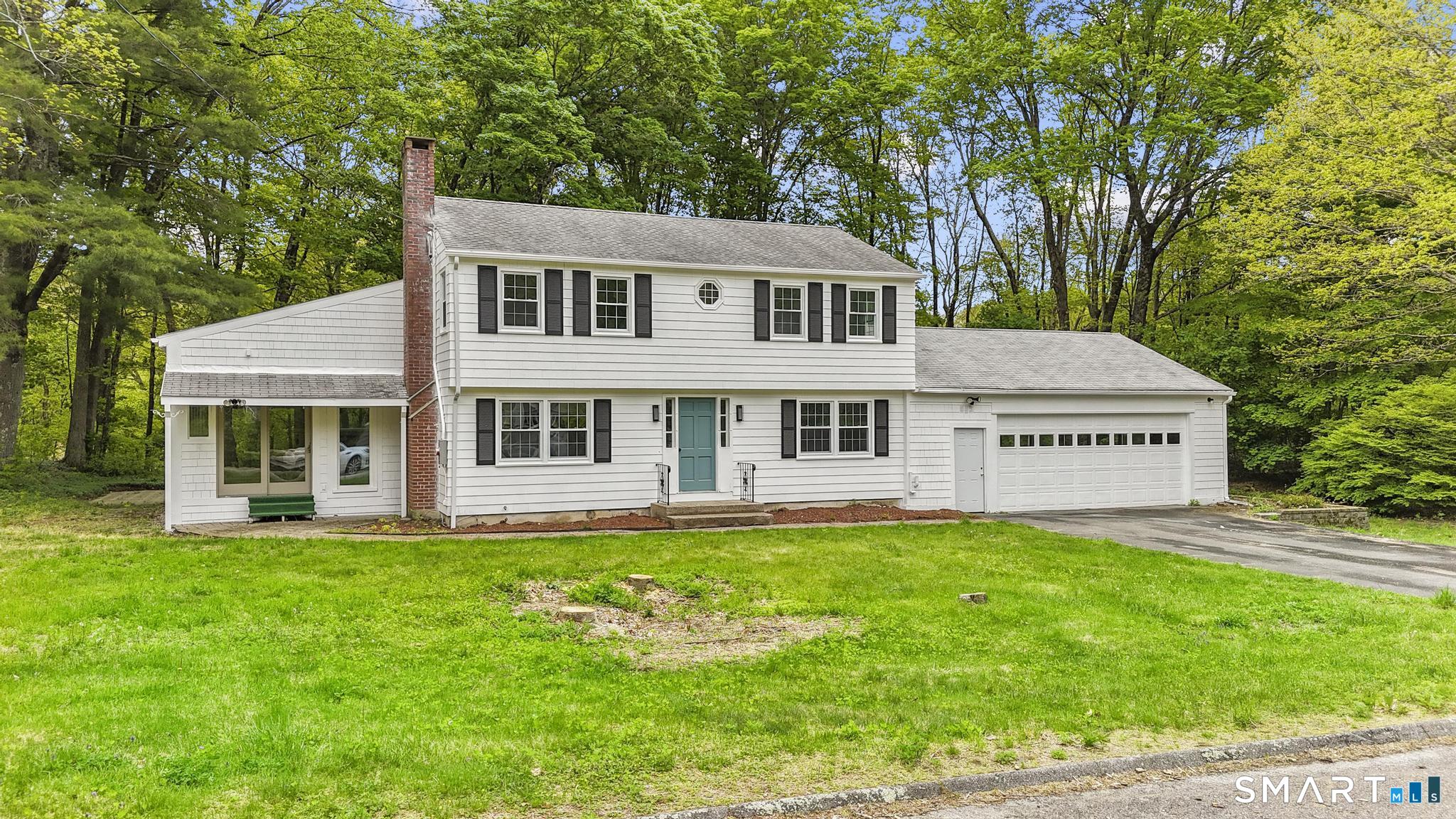 7 Sycamore Terrace Windham, CT 06280 - Photo 2 of 40 a house that has a big yard with potted plants and big trees