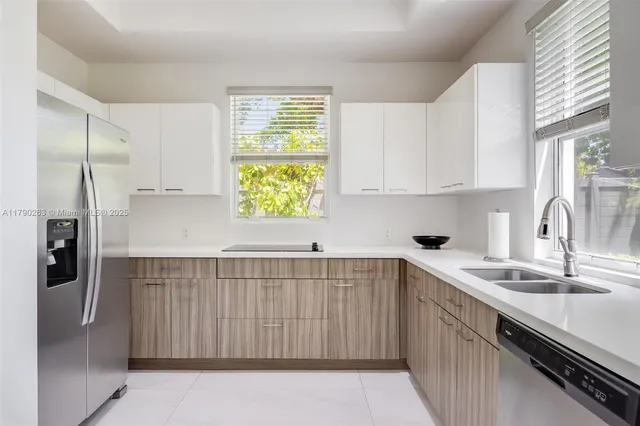 a kitchen with a sink appliances and cabinets