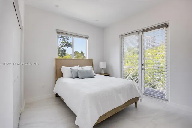 a bedroom with a large bed and a window