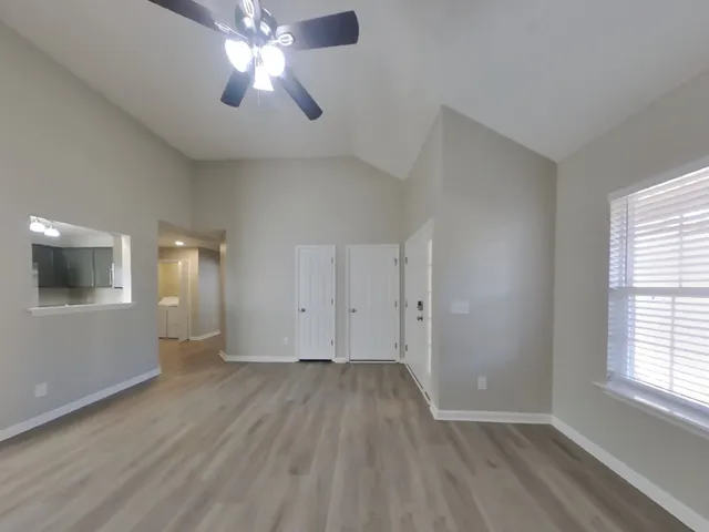 wooden floor in an empty room with a window