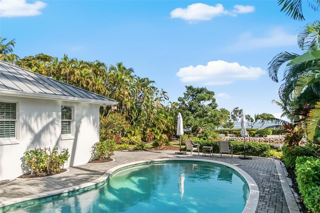 5382 Sandhamn Place Longboat Key, FL 34228 - Photo 11 of 55 a swimming pool with outdoor seating and plants