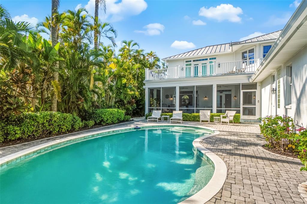 5382 Sandhamn Place Longboat Key, FL 34228 - Photo 12 of 55 a view of a house with swimming pool and porch with furniture